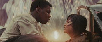 Movie still from “Star Wars: Episode VIII - The Last Jedi” (2017), directed by Rian Johnson – A man and a woman face to face in front of trees; Close Up shot, Low angle