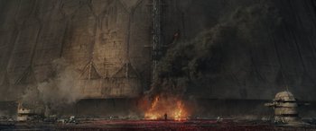 Movie still from “Star Wars: Episode VIII - The Last Jedi” (2017), directed by Rian Johnson – A man standing in front of a burning building; Extreme Wide shot, Low angle