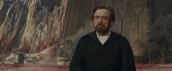 Movie still from “Star Wars: Episode VIII - The Last Jedi” (2017), directed by Rian Johnson – A man with a beard and a black robe; Medium shot, Over the shoulder angle