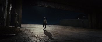 Movie still from “Star Wars: Episode VIII - The Last Jedi” (2017), directed by Rian Johnson – A man holding a baseball bat on a street at night; Extreme Wide shot, Low angle