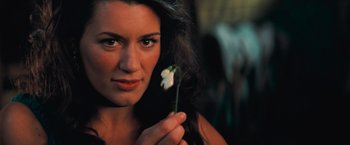 Movie still from “Stardust” (2007), directed by Matthew Vaughn – A beautiful woman holding a white flower in front of her face; Close Up shot, High angle