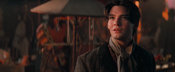 Movie still from “Stardust” (2007), directed by Matthew Vaughn – A man in a suit and tie standing in front of a carousel; Close Up shot, Low angle