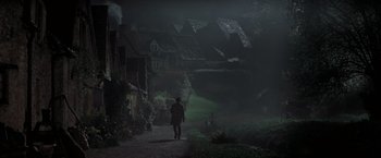Movie still from “Stardust” (2007), directed by Matthew Vaughn – A man walking down a path in the middle of the night; Extreme Wide shot, High angle