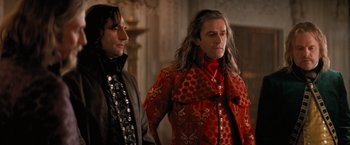 Movie still from “Stardust” (2007), directed by Matthew Vaughn – A man in a red coat stands next to another man in a black jacket; Medium shot, Low angle
