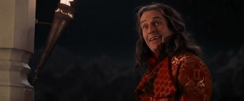 Movie still from “Stardust” (2007), directed by Matthew Vaughn – A man with long black hair wearing a red and black outfit; Medium shot, Over the shoulder angle