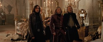 Movie still from “Stardust” (2007), directed by Matthew Vaughn – A group of men standing next to each other in a room; Medium shot, Low angle