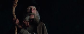 Movie still from “Stardust” (2007), directed by Matthew Vaughn – An old man with a long beard wearing a black hat; Close Up shot, Low angle