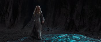 Movie still from “Stardust” (2007), directed by Matthew Vaughn – A woman standing in front of a tree trunk; Wide shot, Low angle