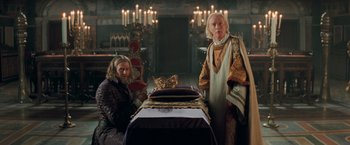 Movie still from “Stardust” (2007), directed by Matthew Vaughn – Two people standing next to a table in a room; Medium shot, High angle