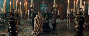 Movie still from “Stardust” (2007), directed by Matthew Vaughn – A group of people standing around a table; Wide shot, High angle