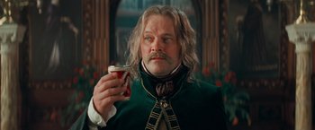 Movie still from “Stardust” (2007), directed by Matthew Vaughn – A person holding a cup in a room; Close Up shot, Low angle