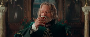 Movie still from “Stardust” (2007), directed by Matthew Vaughn – A man with long hair is eating a sandwich; Close Up shot, Low angle