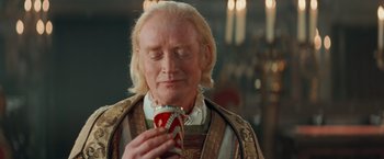 Movie still from “Stardust” (2007), directed by Matthew Vaughn – An old man holding a red cup in his hands; Close Up shot, Over the shoulder angle