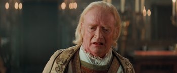 Movie still from “Stardust” (2007), directed by Matthew Vaughn – An old man with long white hair wearing a wig; Close Up shot, Over the shoulder angle