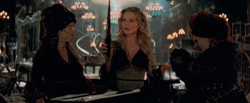 Movie still from “Stardust” (2007), directed by Matthew Vaughn – A woman in a black dress holding a black umbrella; Medium shot, Over the shoulder angle
