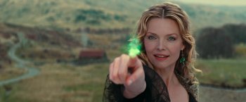 Movie still from “Stardust” (2007), directed by Matthew Vaughn – A woman pointing to the camera with a green object in her hand; Close Up shot, High angle