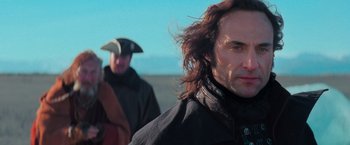 Movie still from “Stardust” (2007), directed by Matthew Vaughn – A man with long brown hair standing next to another man; Close Up shot, Over the shoulder angle
