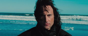Movie still from “Stardust” (2007), directed by Matthew Vaughn – A person wearing a jacket near the ocean; Close Up shot, Low angle