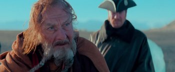 Movie still from “Stardust” (2007), directed by Matthew Vaughn – A man sitting next to another man on a beach; Close Up shot, Over the shoulder angle