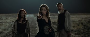 Movie still from “Stardust” (2007), directed by Matthew Vaughn – A woman in a black dress pointing to the camera; Medium shot, Over the shoulder angle