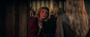 Movie still from “Stardust” (2007), directed by Matthew Vaughn – A woman with long blonde hair wearing a red dress; Close Up shot, Over the shoulder angle