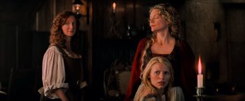 Movie still from “Stardust” (2007), directed by Matthew Vaughn – A group of people standing in a living room; Medium shot, Over the shoulder angle