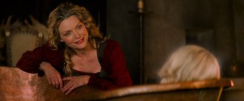 Movie still from “Stardust” (2007), directed by Matthew Vaughn – A woman sitting in front of a mirror smiling for the camera; Close Up shot, Over the shoulder angle