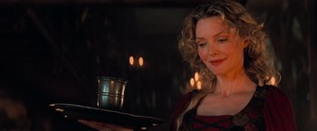 Movie still from “Stardust” (2007), directed by Matthew Vaughn – A woman holding a tray of food in front of candles; Close Up shot, Over the shoulder angle