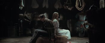 Movie still from “Stardust” (2007), directed by Matthew Vaughn – A man and a woman sitting on top of a couch; Wide shot, High angle