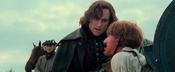 Movie still from “Stardust” (2007), directed by Matthew Vaughn – A man with long brown hair standing next to another man with long red hair; Close Up shot, Over the shoulder angle