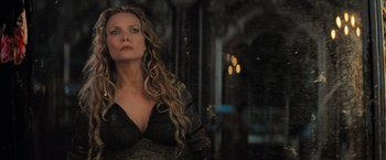 Movie still from “Stardust” (2007), directed by Matthew Vaughn – A woman with long blonde curly hair wearing a black dress; Close Up shot, Low angle