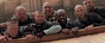 Movie still from “Stardust” (2007), directed by Matthew Vaughn – A group of men standing next to each other on a ledge; Medium shot, Low angle