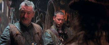 Movie still from “Stardust” (2007), directed by Matthew Vaughn – A man in brown jacket standing next to another man; Close Up shot, Over the shoulder angle