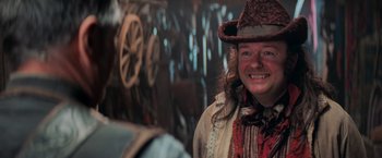 Movie still from “Stardust” (2007), directed by Matthew Vaughn – A woman in a cowboy hat smiling for the camera; Close Up shot, Over the shoulder angle