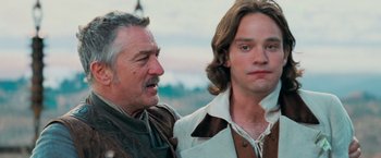 Movie still from “Stardust” (2007), directed by Matthew Vaughn – A man standing next to another man in a field; Close Up shot, Over the shoulder angle