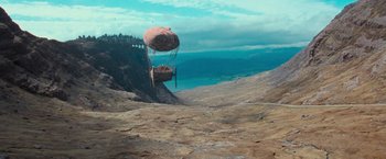 Movie still from “Stardust” (2007), directed by Matthew Vaughn – An air balloon flying over a cliff with a view of the ocean below it; Extreme Wide shot, High angle