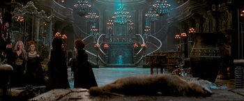 Movie still from “Stardust” (2007), directed by Matthew Vaughn – A woman standing in front of a staircase in a dark room; Wide shot, High angle