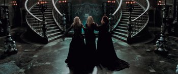 Movie still from “Stardust” (2007), directed by Matthew Vaughn – A group of three women standing next to each other in front of a staircase; Wide shot, High angle