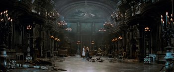 Movie still from “Stardust” (2007), directed by Matthew Vaughn – Two people standing in an ornate room with chandeliers; Extreme Wide shot, High angle