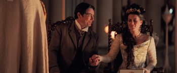 Movie still from “Stardust” (2007), directed by Matthew Vaughn – A man and a woman holding hands while sitting in a chair; Medium shot, Over the shoulder angle