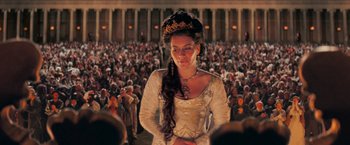Movie still from “Stardust” (2007), directed by Matthew Vaughn – A woman in a white dress standing in front of a crowd of onlookers; Medium shot, High angle