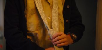 Movie still from “Stargirl” (2020), directed by Julia Hart – A person holding a tie in their hands; Extreme Close Up shot, High angle