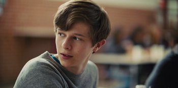 Movie still from “Stargirl” (2020), directed by Julia Hart – A young man is looking into the distance; Close Up shot, Over the shoulder angle