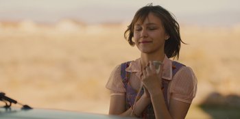 Movie still from “Stargirl” (2020), directed by Julia Hart – A woman holding a cell phone up to her face; Close Up shot, Over the shoulder angle