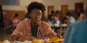 Movie still from “Stargirl” (2020), directed by Julia Hart – A person sitting at a table with a plate of food; Close Up shot, Over the shoulder angle