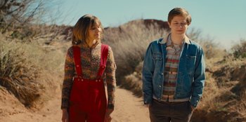 Movie still from “Stargirl” (2020), directed by Julia Hart – Two people standing on a dirt path in the desert; Medium shot, Over the shoulder angle