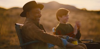Movie still from “Stargirl” (2020), directed by Julia Hart – A man and a boy riding a bike in the desert; Medium shot, Over the shoulder angle