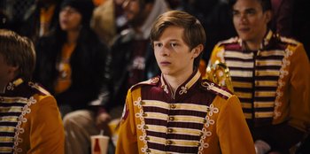 Movie still from “Stargirl” (2020), directed by Julia Hart – A young man in a military uniform stands in front of a group of people; Medium shot, High angle