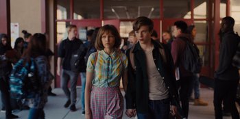 Movie still from “Stargirl” (2020), directed by Julia Hart – A man and a woman holding hands while standing next to each other; Medium shot, Low angle