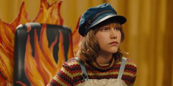 Movie still from “Stargirl” (2020), directed by Julia Hart – A woman in a blue hat and a striped sweater; Close Up shot, High angle
